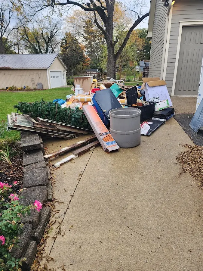 Dumpster being loaded with debris for 12 Yard Dumpster Rental in Leavenworth